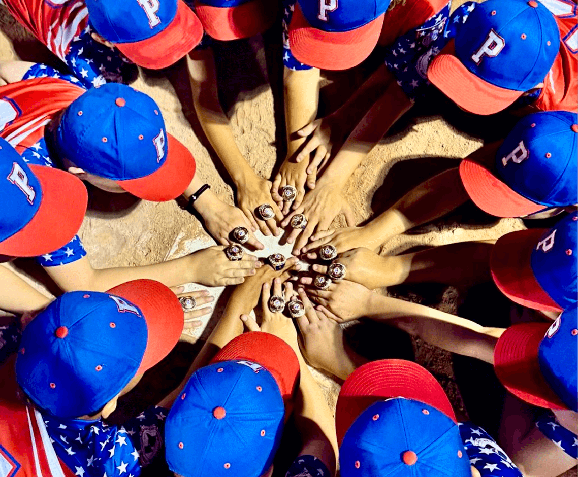 Youth baseball team showing championship rings